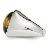 A silver ring with a large oval cabochon stone in golden brown tiger's eye, shown from the side against a white background.