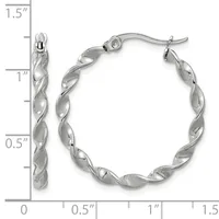 Pair of twisted silver hoop earrings with post and clutch backs, displayed next to a ruler showing them to be approximately 1.25 inches in diameter.