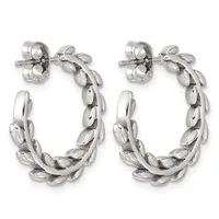 A pair of silver-toned twisted hoop earrings with leaf-shaped segments arranged in a braided pattern, shown from the front against a white background.
