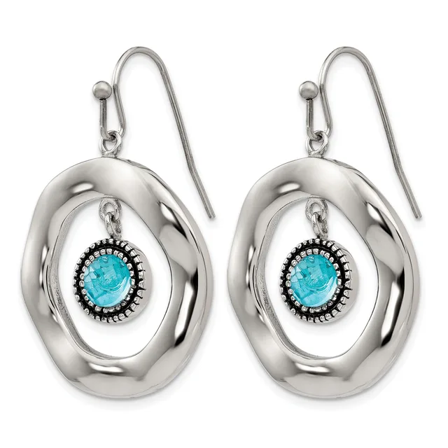 A pair of silver drop earrings with oval loops featuring turquoise stones surrounded by decorative beading, suspended from curved silver hooks.