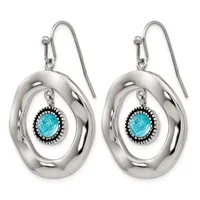 A pair of silver drop earrings with oval loops featuring turquoise stones surrounded by decorative beading, suspended from curved silver hooks.