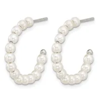 A pair of silver hoop earrings with white pearl beads strung along the curved wire, shown from the front.