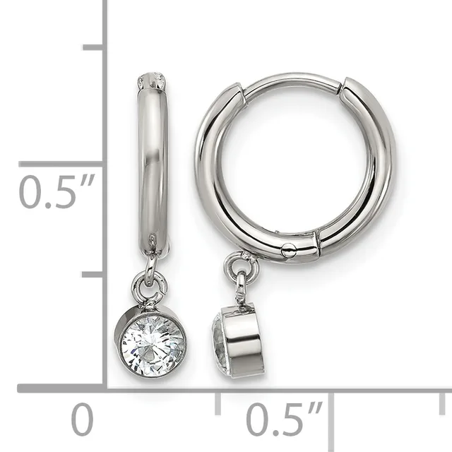 A pair of silver hoop earrings with detachable charms, one featuring a round cubic zirconia stone and the other a polished silver cylinder, shown next to a measurement scale.