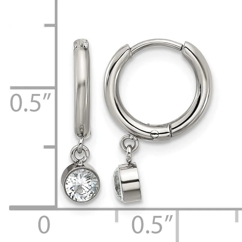 A pair of silver hoop earrings with detachable charms, one featuring a round cubic zirconia stone and the other a polished silver cylinder, shown next to a measurement scale.