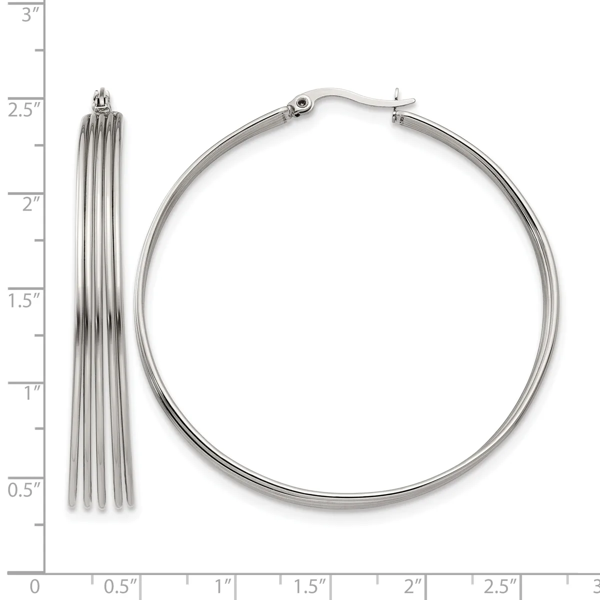 Two silver-toned metal earrings displayed against a ruler: a tassel-style drop earring and a polished hoop earring, each approximately 2.5 inches long.