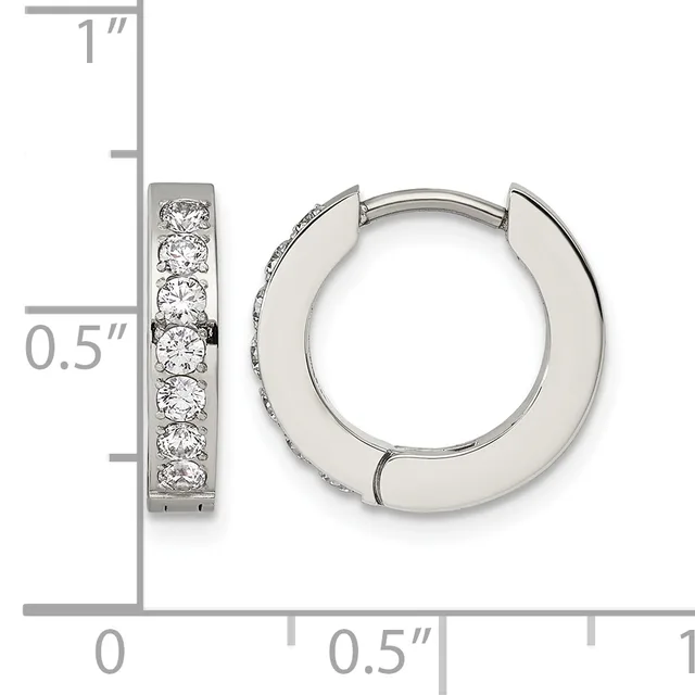 A pair of silver hoop earrings with channel-set round diamonds, shown with a measurement scale indicating approximately one inch in height and half an inch in width.