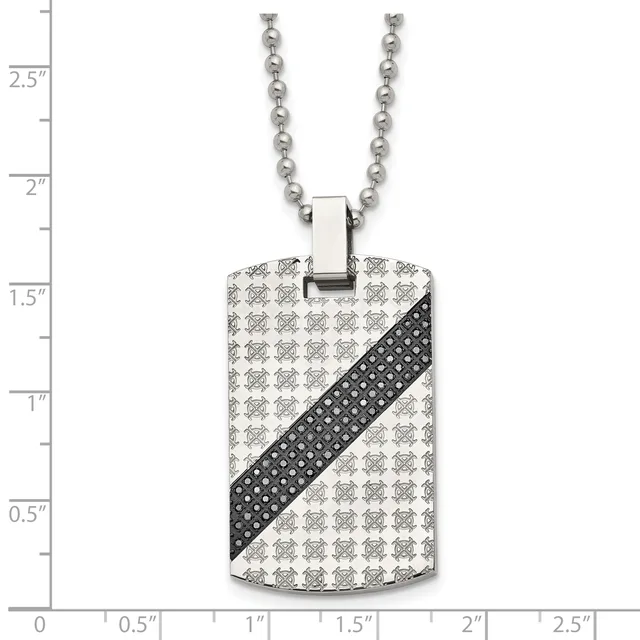 Stainless steel dog tag pendant with repeating skull pattern and black diagonal stripe, suspended from a ball chain, displayed against a measurement ruler.