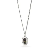 Silver pendant necklace with rectangular charm featuring black oval center engraved with "DAD" in gold lettering, suspended from a thin chain.