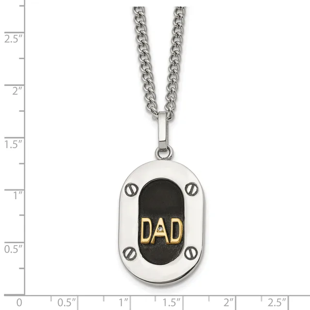 Stainless steel pendant necklace with oval dog tag design featuring black center with gold "DAD" text, silver screw details, and curb chain, shown against ruler measuring approximately 2.5 inches long.