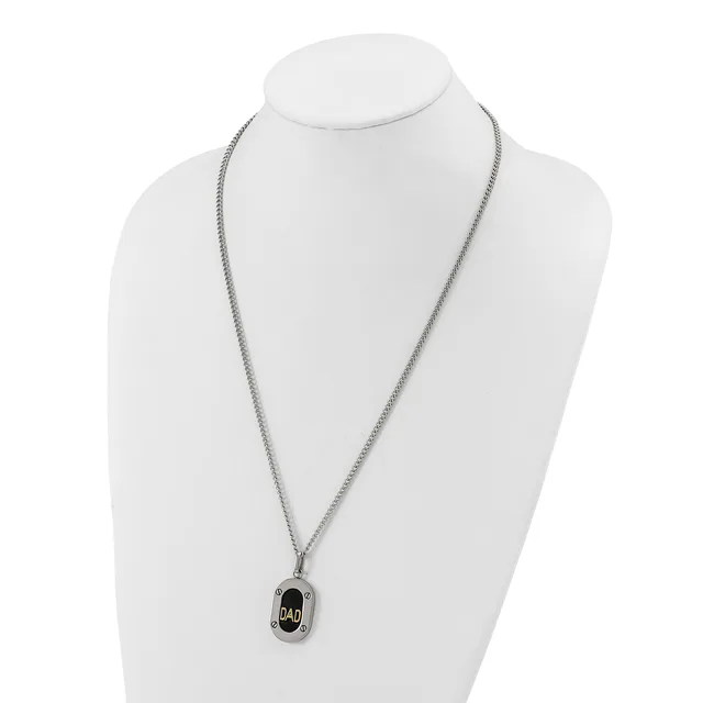 Silver-toned chain necklace with a small rectangular black pendant featuring a stamped hallmark, displayed on a white mannequin bust.