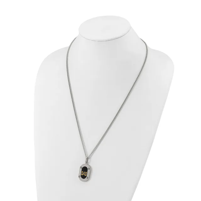 Silver-toned chain necklace with a small rectangular pendant featuring a black oval center with gold-toned accents, displayed on a white mannequin bust.