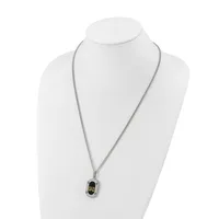 Silver-toned chain necklace with a small rectangular pendant featuring a black oval center with gold-toned accents, displayed on a white mannequin bust.