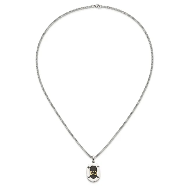 Silver-toned chain necklace with a small oval pendant featuring black enamel and gold lettering, displayed against a white background.