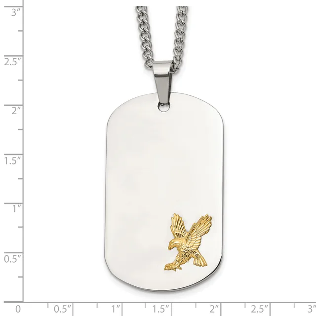 Silver dog tag pendant with gold eagle design, suspended from a silver curb chain, shown against a measurement scale.
