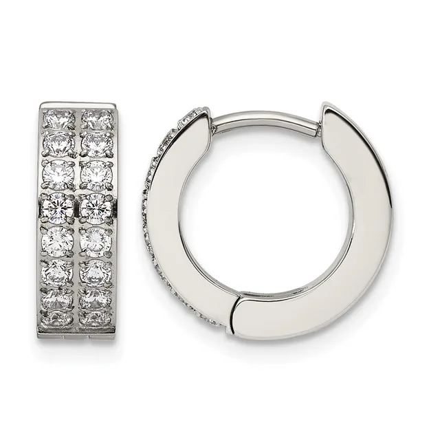 A pair of silver hoop earrings, one displaying round diamonds set in two columns and one showing a polished plain design with a small hallmark.