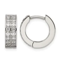 A pair of silver hoop earrings, one displaying round diamonds set in two columns and one showing a polished plain design with a small hallmark.