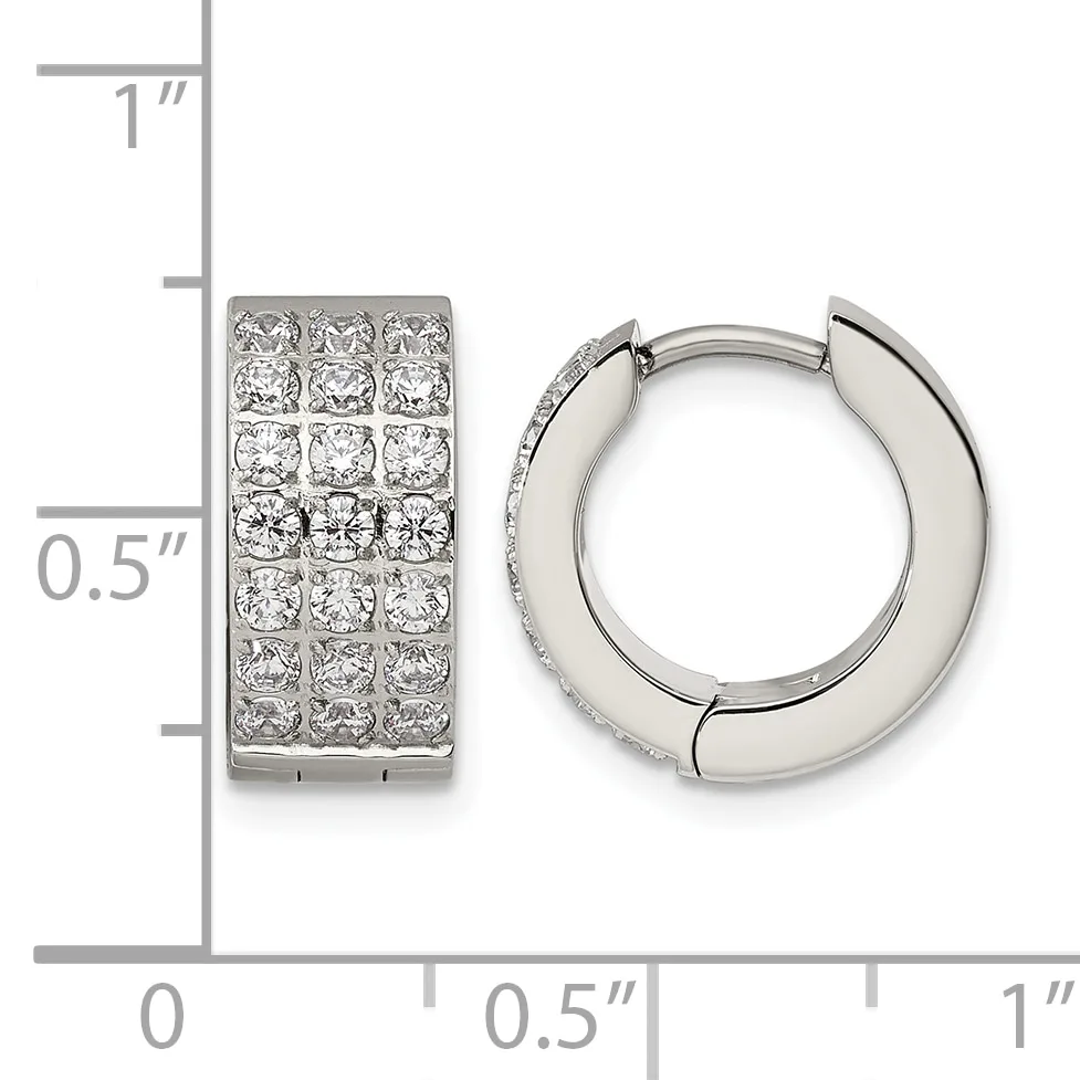 A pair of silver huggie hoop earrings with pave-set cubic zirconia stones, shown next to a ruler indicating their dimensions of approximately one inch tall and half inch wide.