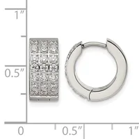 A pair of silver huggie hoop earrings with pave-set cubic zirconia stones, shown next to a ruler indicating their dimensions of approximately one inch tall and half inch wide.