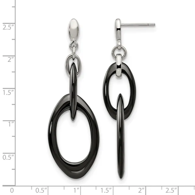 A pair of black and silver dangle earrings with oval black rings suspended from silver studs, displayed against a measurement scale showing approximately two inches in length.