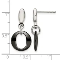 A pair of two-tone drop earrings with polished silver oval tops and black circular rings hanging below, displayed against a measurement scale.