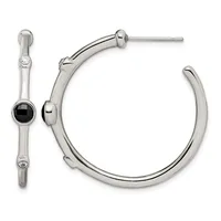 A pair of silver-tone hoop earrings, one featuring a black onyx stone accent, displayed against a white background.
