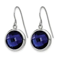 A pair of silver dangle earrings with round faceted dark blue gemstones set in polished bezels, suspended from thin curved ear wires.