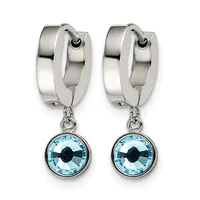Pair of silver-tone hoop earrings with light blue round crystal pendants featuring dark blue centers.