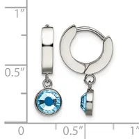 Pair of silver-tone huggie hoop earrings with blue crystal pendant charms, shown against a measurement scale indicating approximately one inch in length.