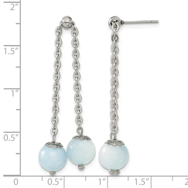 A pair of silver chain dangle earrings with light blue spherical stones, displayed against a ruler showing measurements up to two inches.