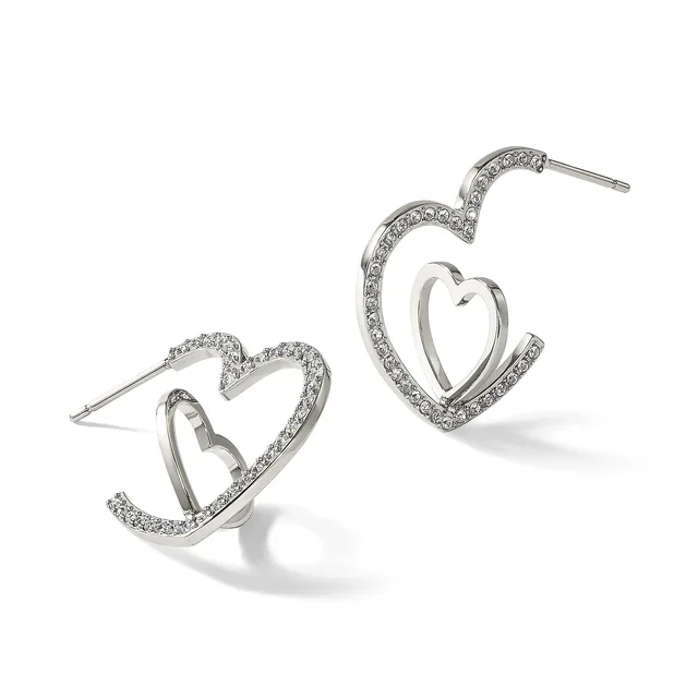 A pair of silver-toned heart-shaped hoop earrings with crystal embellishments along the outer edges, shown from front and side angles.