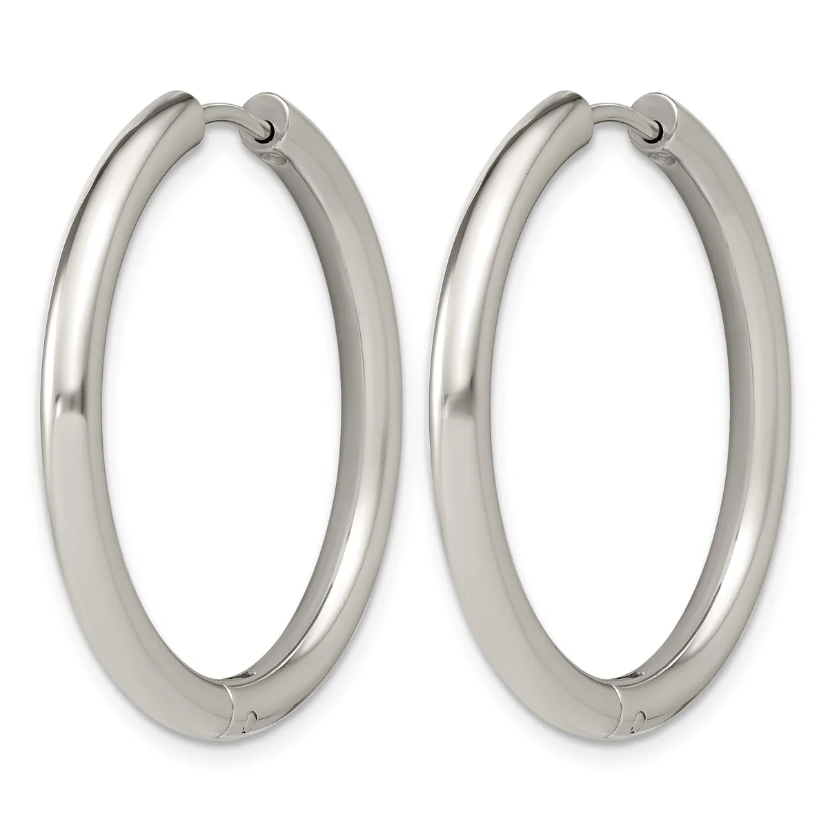 A pair of polished silver-toned hoop earrings with a thick tubular design and hinged closures, shown against a white background.