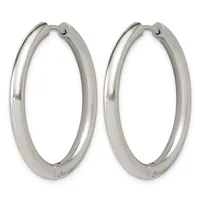 A pair of polished silver-toned hoop earrings with a thick tubular design and hinged closures, shown against a white background.