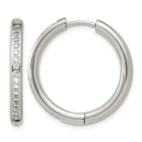 A pair of silver hoop earrings with hinged closures, one shown from the front and one displaying diamond or crystal stone settings along its inner surface.