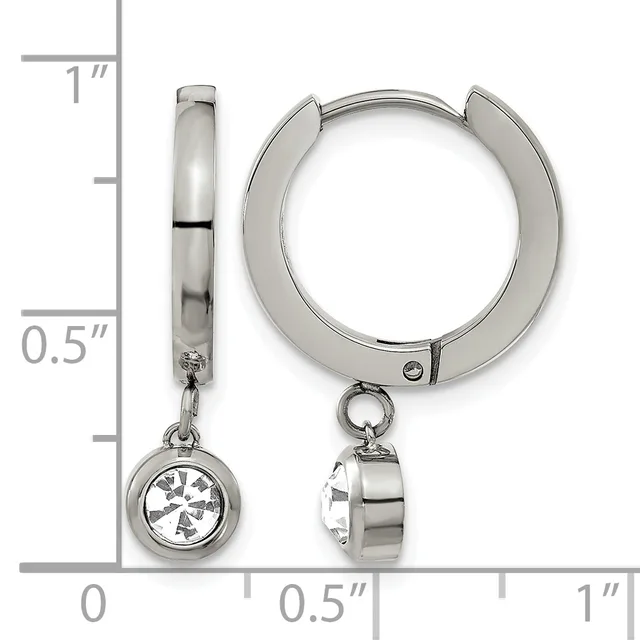 A pair of polished silver-toned hug earrings with dangling round charms set with clear gemstones, shown next to a measurement ruler.