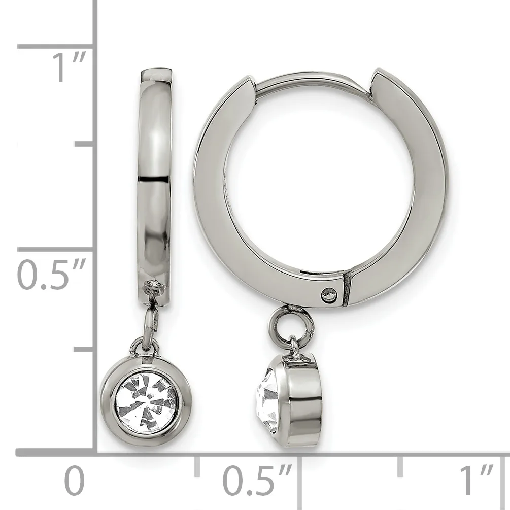 A pair of polished silver-toned hug earrings with dangling round charms set with clear gemstones, shown next to a measurement ruler.