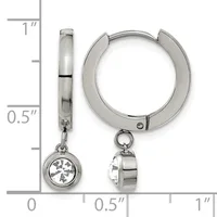 A pair of polished silver-toned hug earrings with dangling round charms set with clear gemstones, shown next to a measurement ruler.