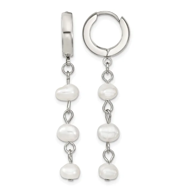 A pair of silver huggie hoop earrings with three white pearl beads dangling from each hoop on chain links.