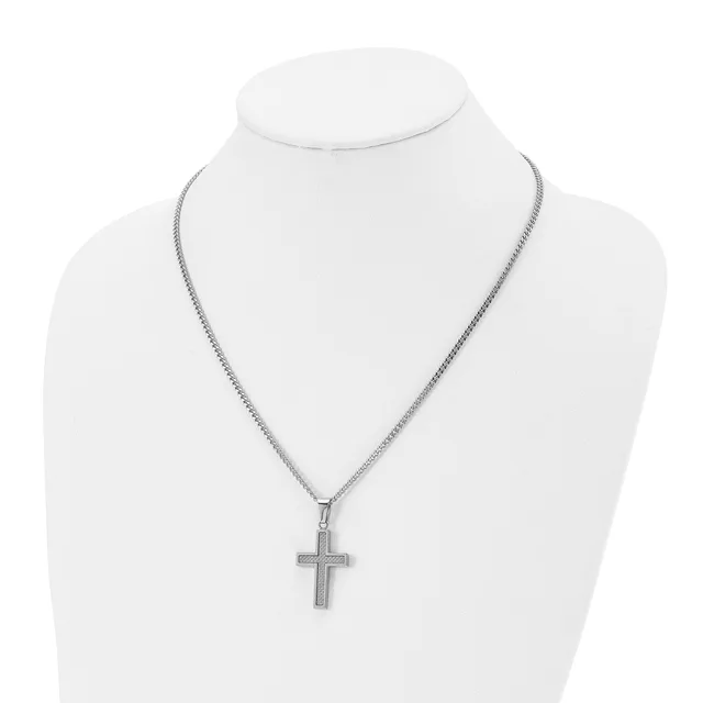 Silver-toned cross pendant hanging from a fine chain necklace, displayed on a white mannequin bust.