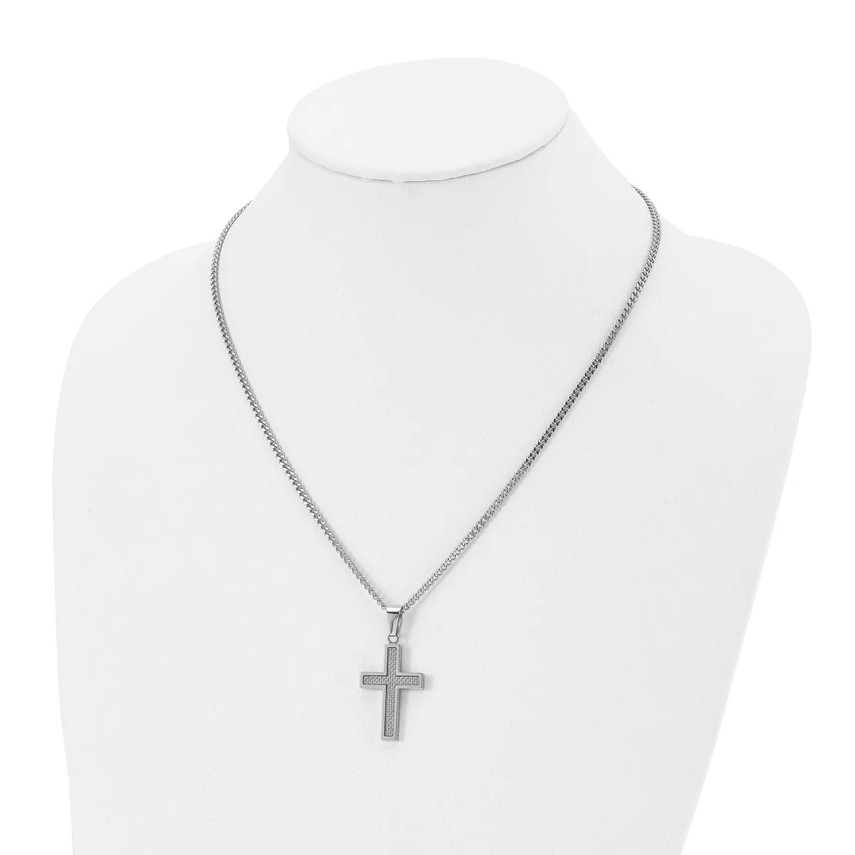 Silver-toned cross pendant hanging from a fine chain necklace, displayed on a white mannequin bust.