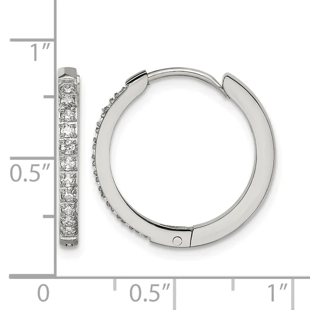 Silver hoop earrings with cubic zirconia stones set along the front, displayed next to a ruler showing approximately one inch in length.