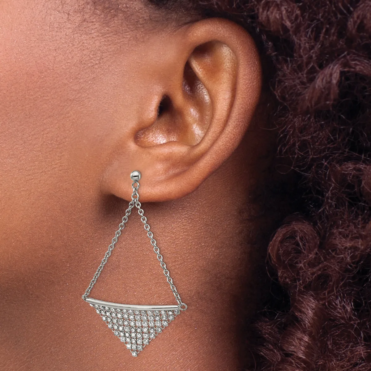A silver-toned dangle earring with a triangular geometric design featuring rhinestone embellishments on the lower half, hanging from a chain attached to an earlobe.