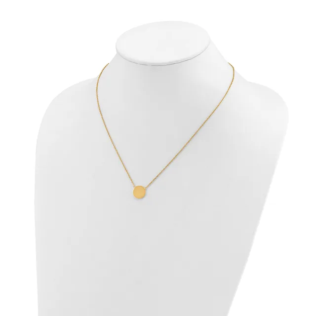 A gold-toned chain necklace with a small round pendant displayed on a white mannequin bust.