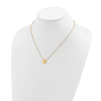 A gold-toned chain necklace with a small round pendant displayed on a white mannequin bust.