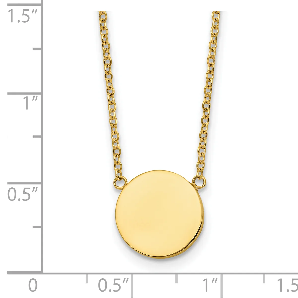 A gold circular pendant hangs from two thin gold chains, shown next to a ruler indicating the pendant is approximately half an inch in diameter.