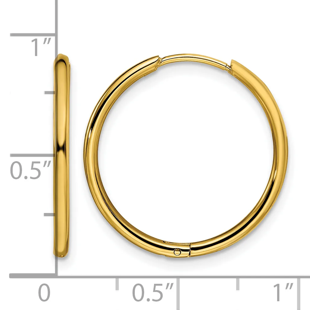 A pair of polished gold-toned hoop earrings with a hinged closure, shown against a measurement scale indicating approximately one inch in diameter.