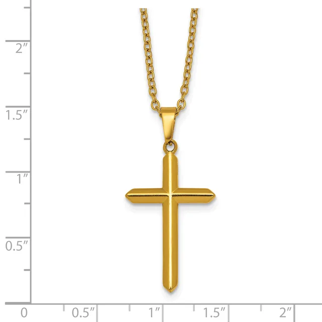 Gold-toned polished cross pendant on a chain necklace, displayed against a measurement scale showing the pendant is approximately one inch tall.