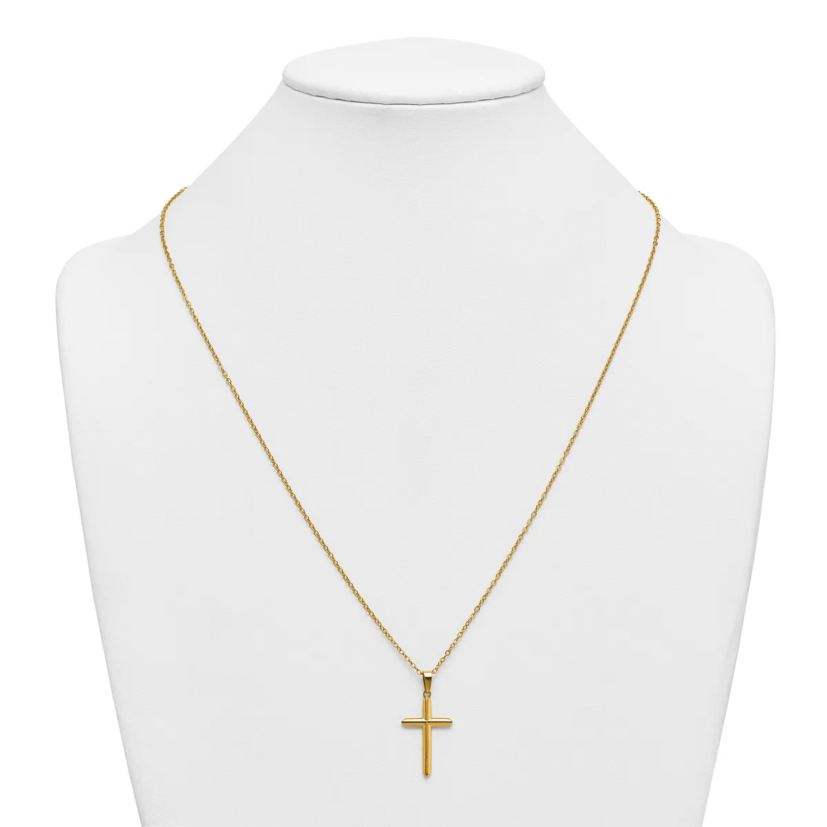 A gold-toned cross pendant hangs from a delicate gold chain on a white bust display form.