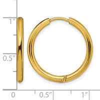 A pair of polished gold-colored hoop earrings with a hinged closure, shown front and side view against a measurement scale indicating approximately one inch in diameter.