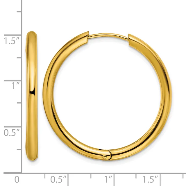 A pair of gold hoop earrings with a polished finish, displayed next to a ruler showing them to be approximately 1.5 inches in diameter.