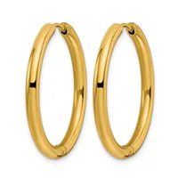 A pair of polished gold-colored oval hoop earrings with a smooth, rounded profile and hinged closures.